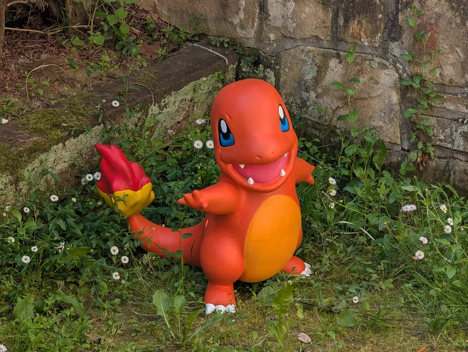 1:1 scale Charmander in a garden